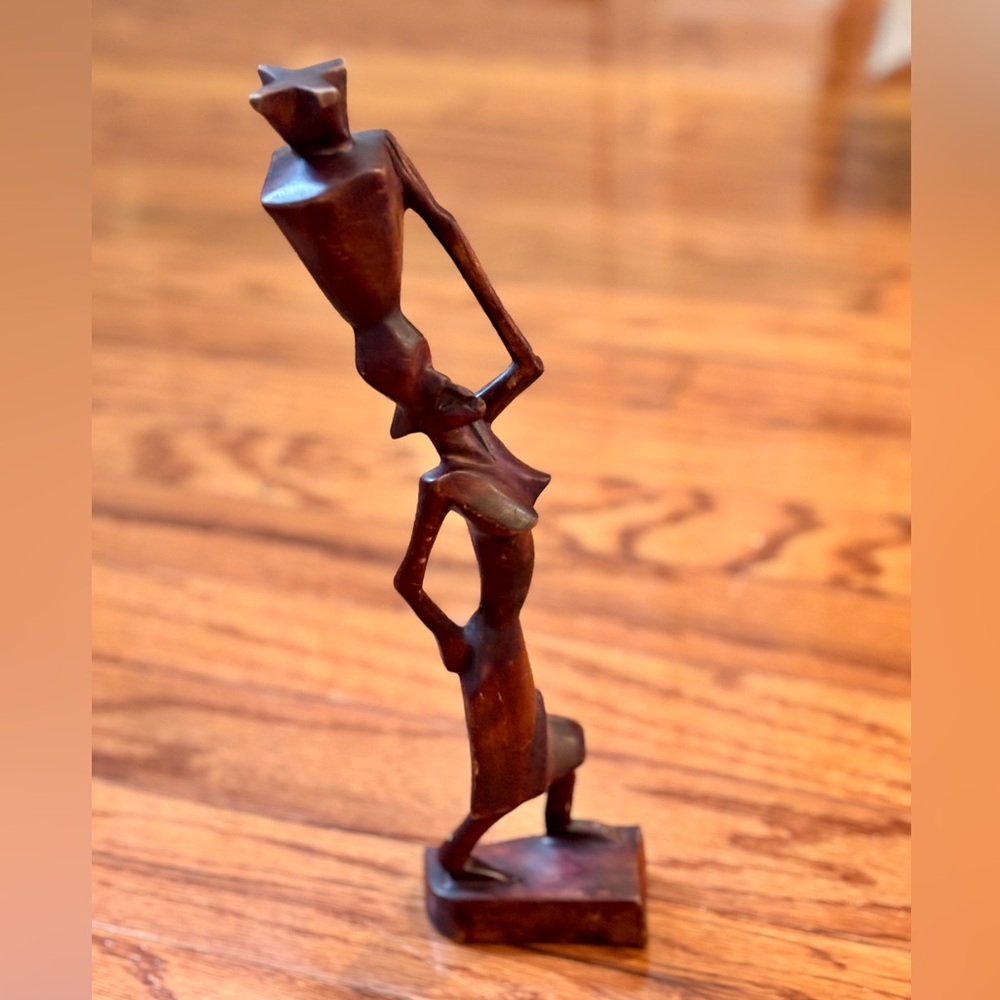 Hand-carved African woman carrying a vessel of water